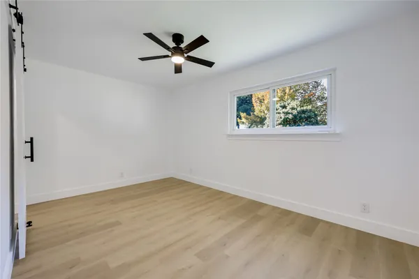 a view of a room with a ceiling fan
