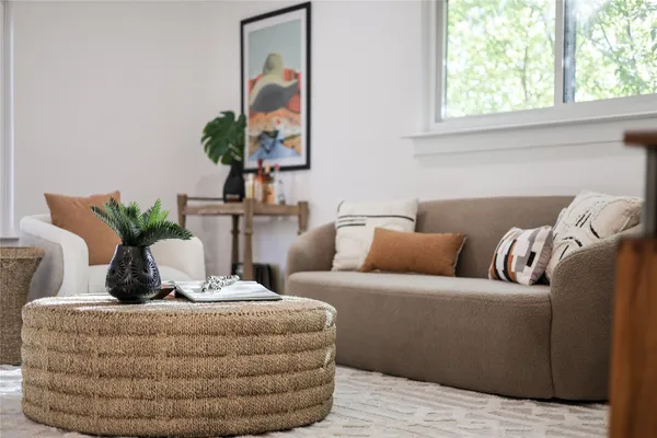 a living room with furniture and a potted plant
