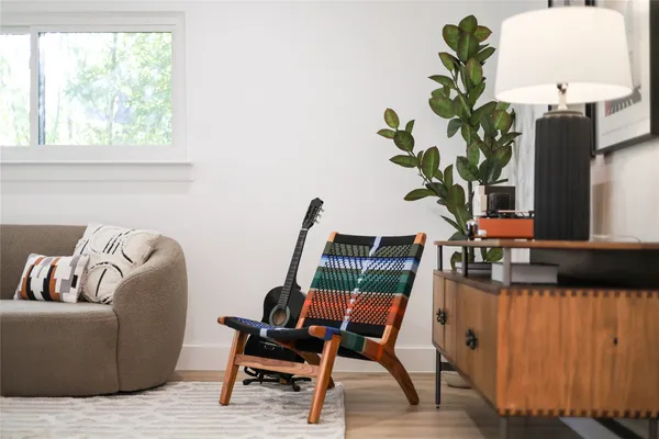 a living room with furniture and a potted plant