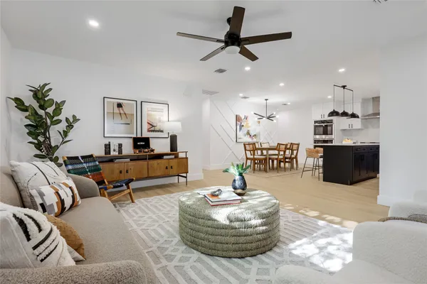 a living room with furniture and kitchen view