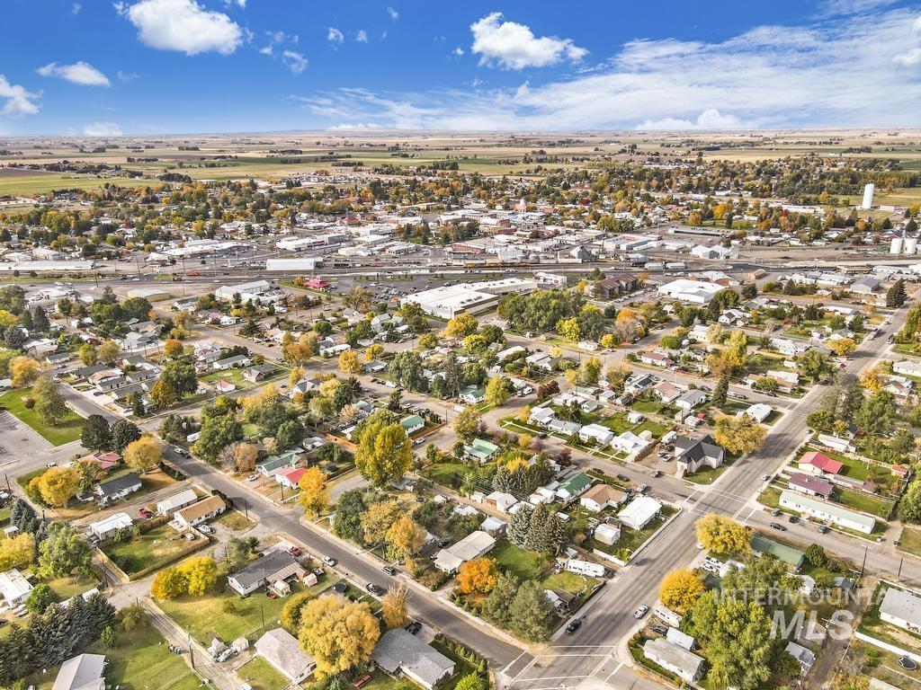111 2nd Street Rupert, ID 83350 - Photo 43 of 45 Aerial perspective showcasing a residential and commercial area with agricultural fields bordering the community