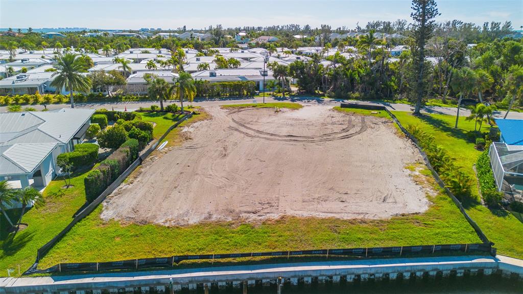 721 Binnacle Point Drive Longboat Key, FL 34228 - Photo 8 of 12 a view of a swimming pool with a yard