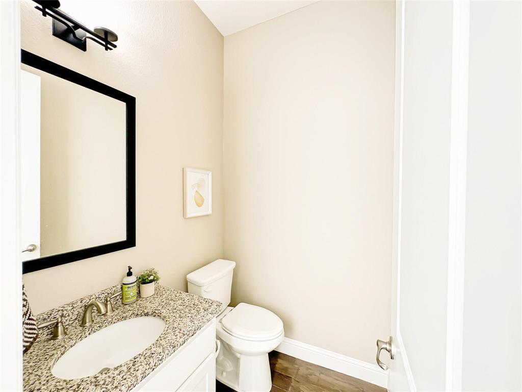 7605 Kickapoo Drive McKinney, TX 75070 - Photo 11 of 18 a bathroom with a granite countertop sink and a mirror