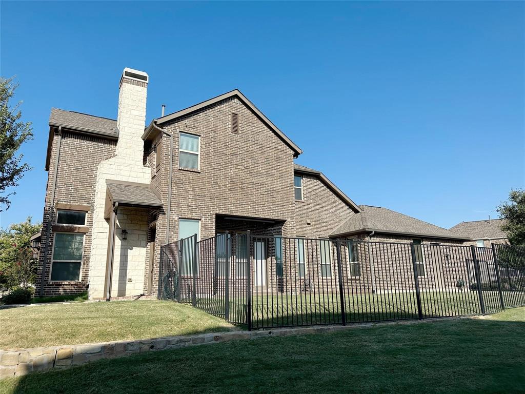 7605 Kickapoo Drive McKinney, TX 75070 - Photo 13 of 18 a front view of a house with a yard
