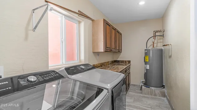 a kitchen with a stove a sink and a window