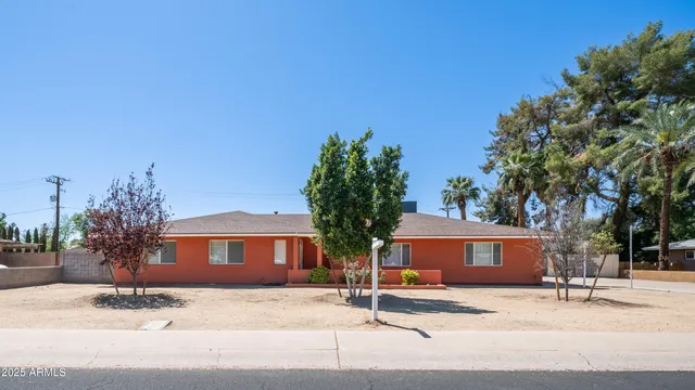 a front view of a house with a yard and a garage
