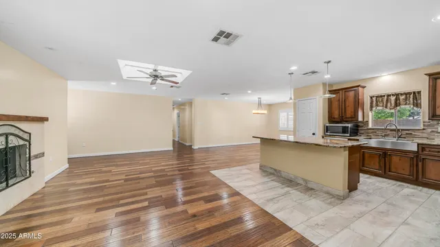 a view of kitchen with sink and refrigerator