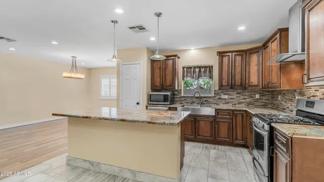 a kitchen with a sink stove and cabinets