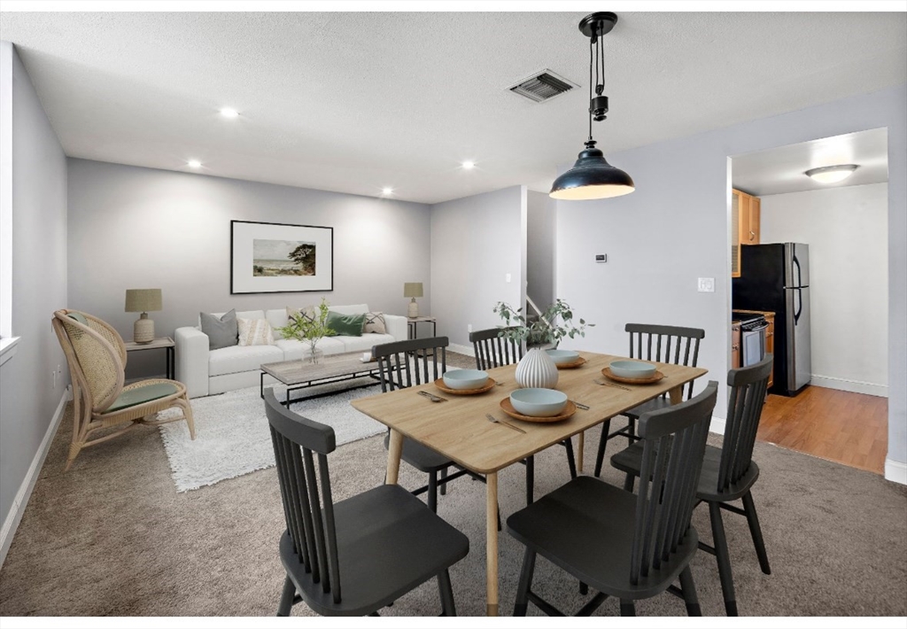 201 Thorndike Street, Unit 205 Lowell, MA 01852 - Photo 13 of 13 a view of a dining room with furniture