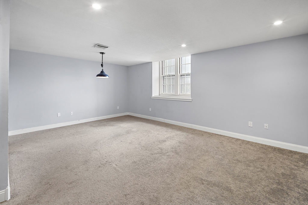 201 Thorndike Street, Unit 205 Lowell, MA 01852 - Photo 3 of 13 an empty room with windows
