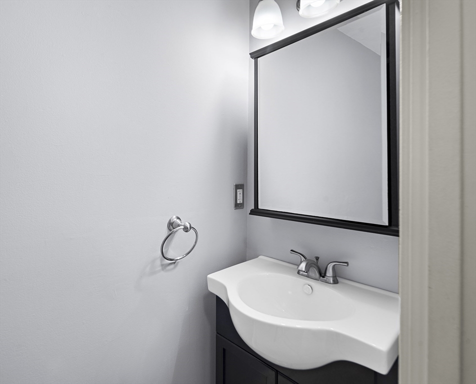 201 Thorndike Street, Unit 205 Lowell, MA 01852 - Photo 6 of 13 a bathroom with a sink and a mirror