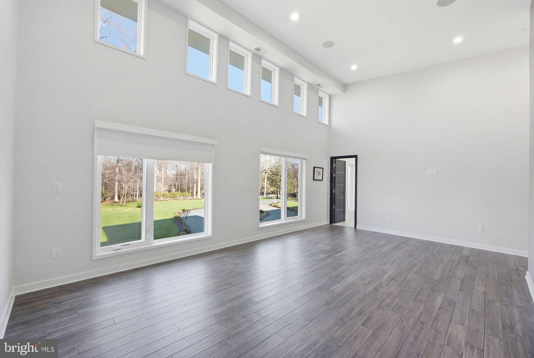 2368 Hunter Mill Road Vienna, VA 22181 - Photo 69 of 74 a view of an empty room with wooden floor and a window