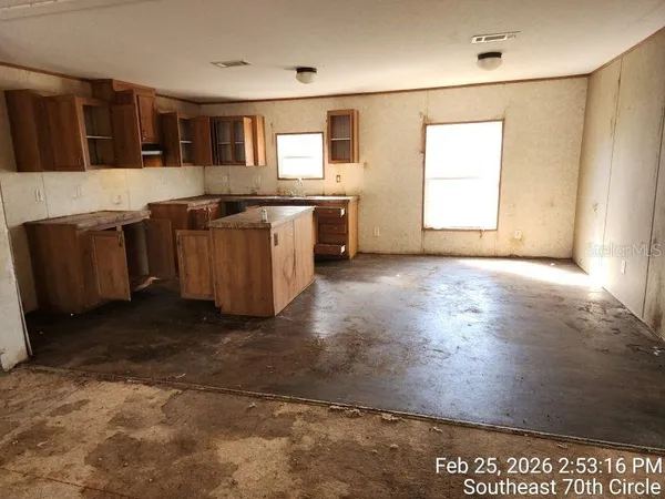 a view of kitchen with granite countertop cabinets and a sink