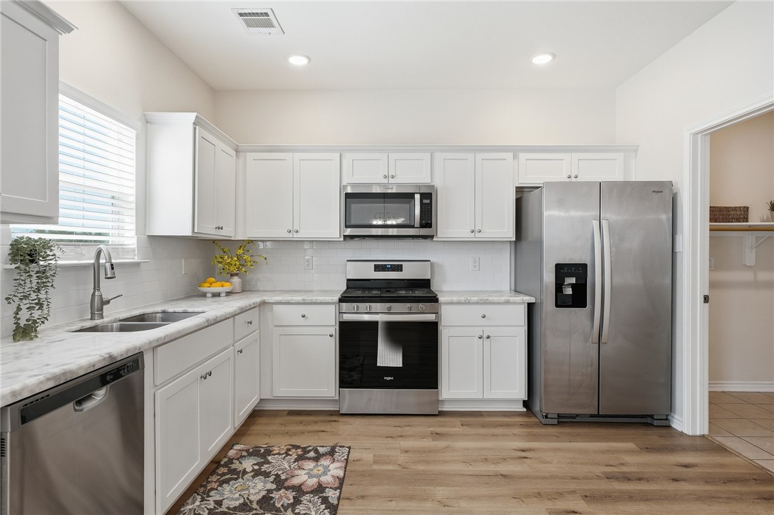 124 Lavaca Rockport, TX 78382 - Photo 13 of 39 a kitchen with a sink stove and refrigerator