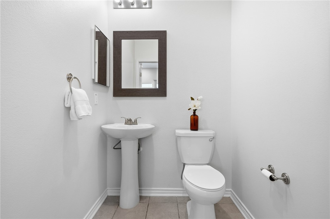 124 Lavaca Rockport, TX 78382 - Photo 15 of 39 a bathroom with a toilet sink and mirror