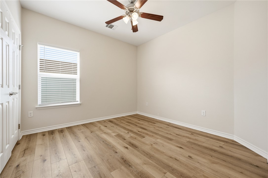 124 Lavaca Rockport, TX 78382 - Photo 20 of 39 wooden floor in an empty room with a window