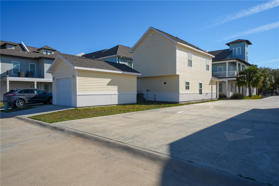 124 Lavaca Rockport, TX 78382 - Photo 28 of 39 a front view of a house with a yard and garage