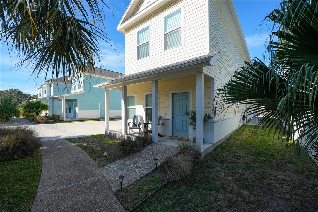 124 Lavaca Rockport, TX 78382 - Photo 4 of 39 a front view of house with yard and trees