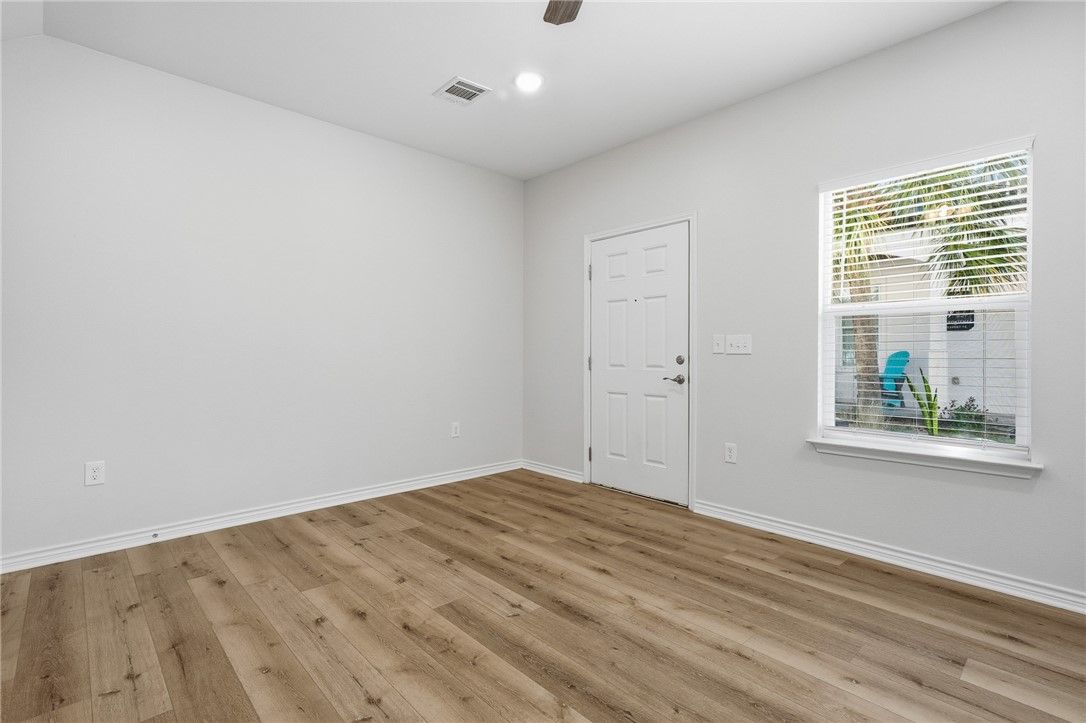 124 Lavaca Rockport, TX 78382 - Photo 5 of 39 an empty room with windows