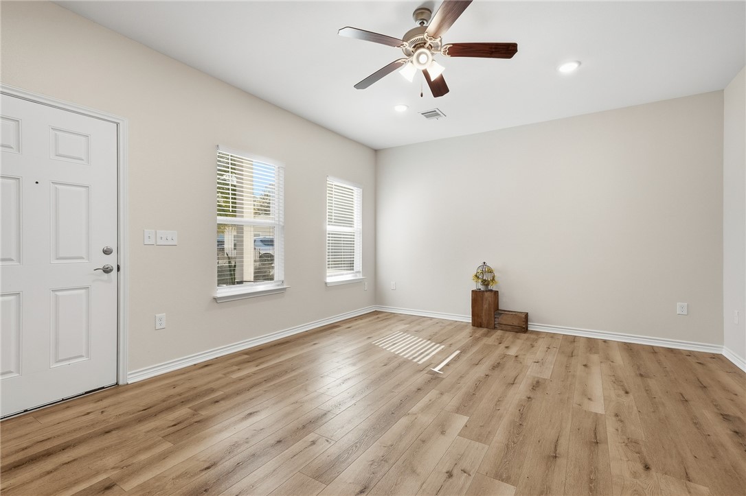 124 Lavaca Rockport, TX 78382 - Photo 7 of 39 an empty room with windows and fan