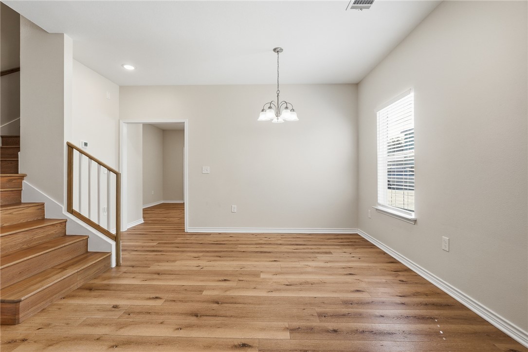 124 Lavaca Rockport, TX 78382 - Photo 10 of 39 a view of an empty room with wooden floor and a window