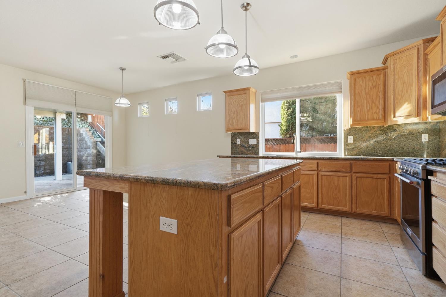 818 Alpine Street Jackson, CA 95642 - Photo 14 of 32 a kitchen with stainless steel appliances granite countertop a sink and a stove