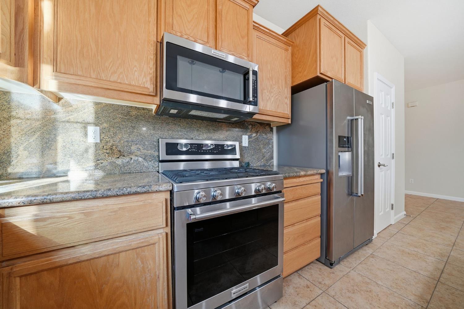 818 Alpine Street Jackson, CA 95642 - Photo 16 of 32 a kitchen with stainless steel appliances granite countertop a stove microwave and refrigerator