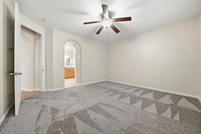 a view of a big room with closet and ceiling fan