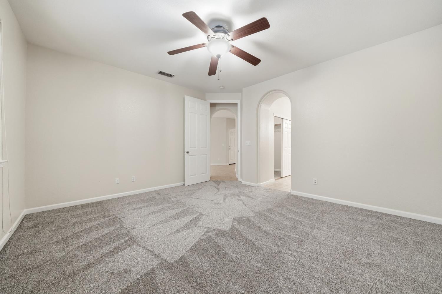 818 Alpine Street Jackson, CA 95642 - Photo 19 of 32 an empty room with chandelier fan and windows