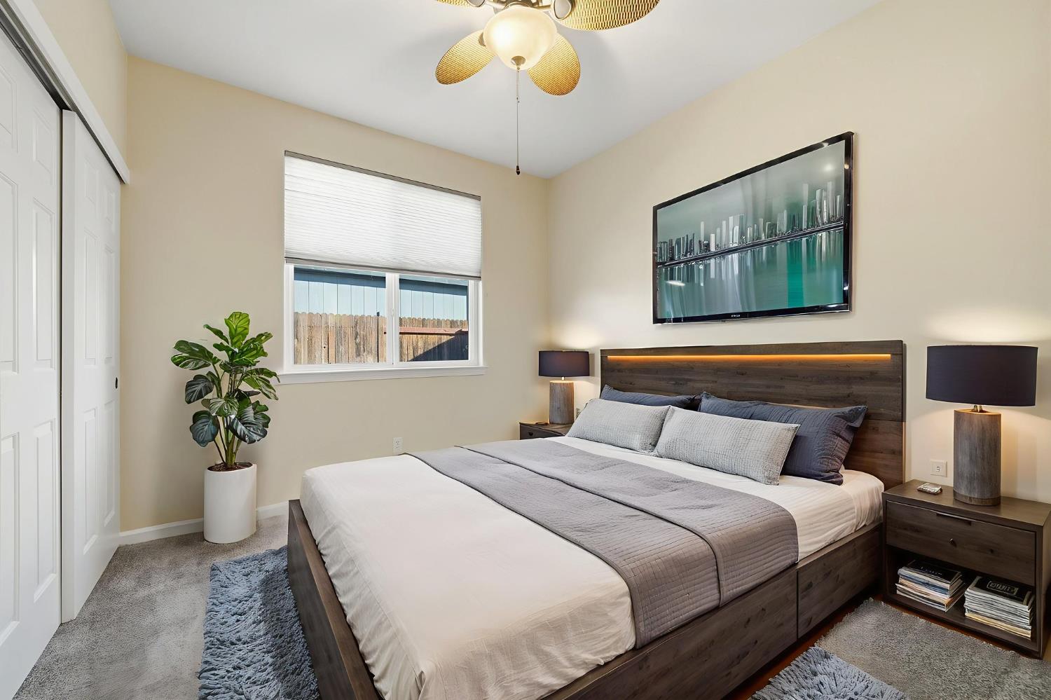 818 Alpine Street Jackson, CA 95642 - Photo 22 of 32 a bedroom with bed and a potted plant