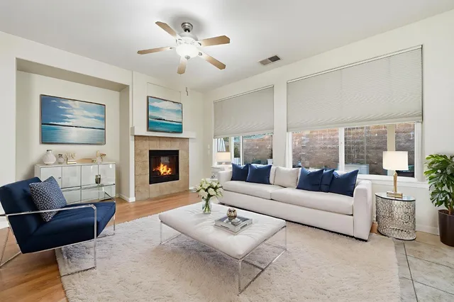 a living room with furniture fireplace and a large window