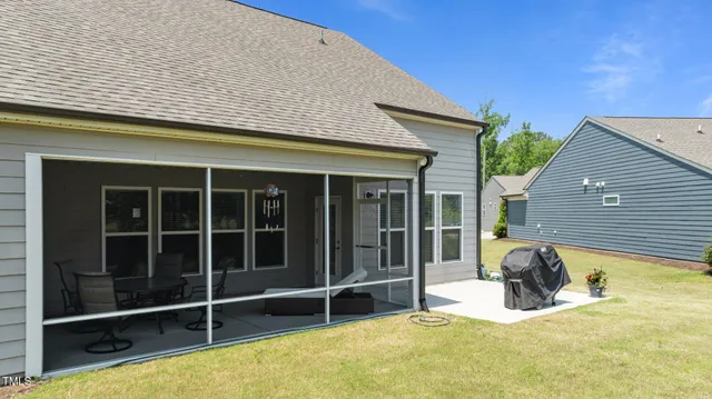 a view of a lounge chair in the backyard of the house