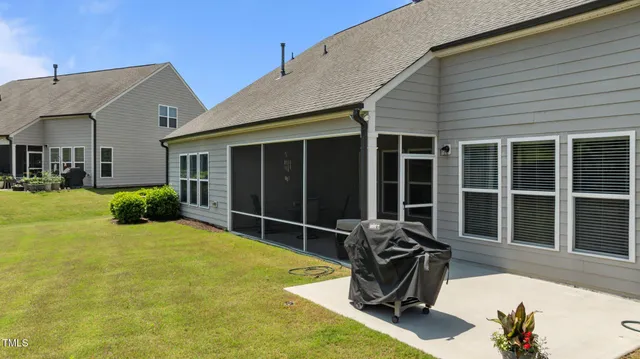 a front view of a house with a yard and potted plants