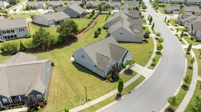 an aerial view of a house with a yard and potted plants