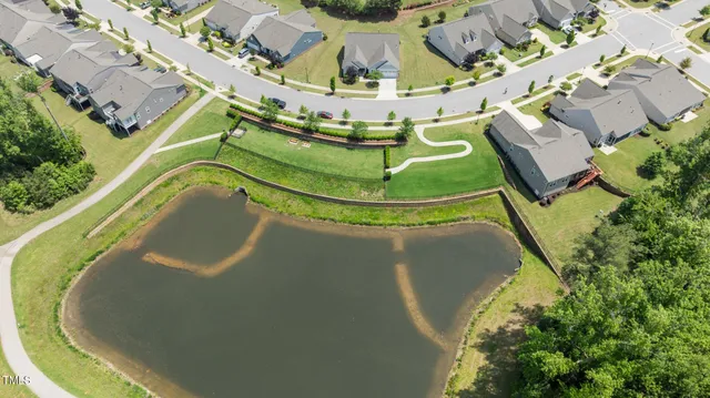 an aerial view of a residential apartment building with a swimming pool