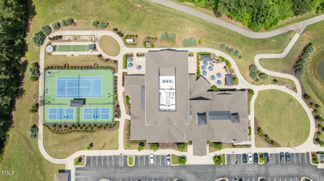 an aerial view of a house with a swimming pool patio and lake view