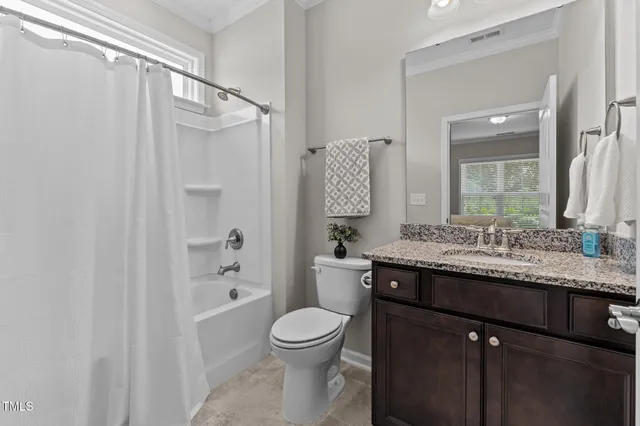 a bathroom with a granite countertop sink toilet a shower and a mirror