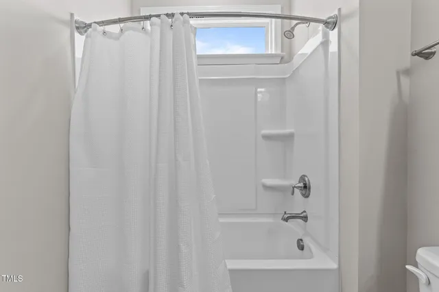 a bathroom with a shower and a bath tub