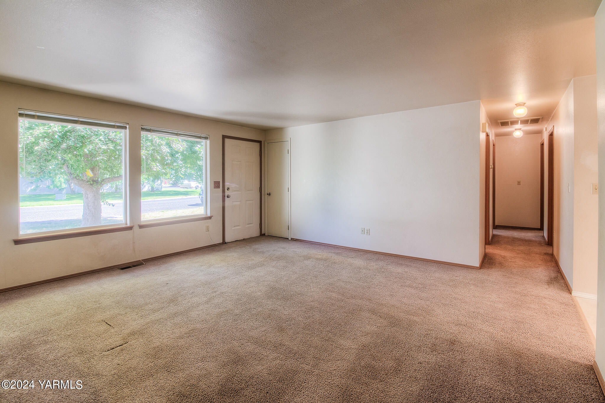 1729 Parsons Loop Yakima, WA 98908 - Photo 3 of 27 an empty room with windows and view of balcony