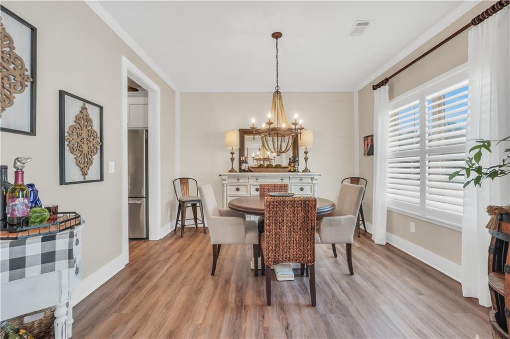 230 Alcovy Reserve Way Covington, GA 30014 - Photo 12 of 53 a view of a dining room with furniture window and wooden floor