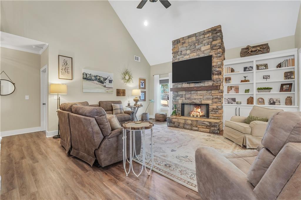 230 Alcovy Reserve Way Covington, GA 30014 - Photo 18 of 53 a living room with furniture a flat screen tv and a fireplace