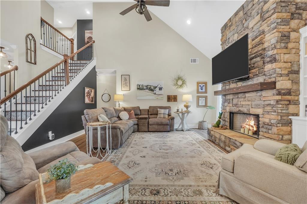 230 Alcovy Reserve Way Covington, GA 30014 - Photo 19 of 53 a living room with furniture a flat screen tv and a fireplace