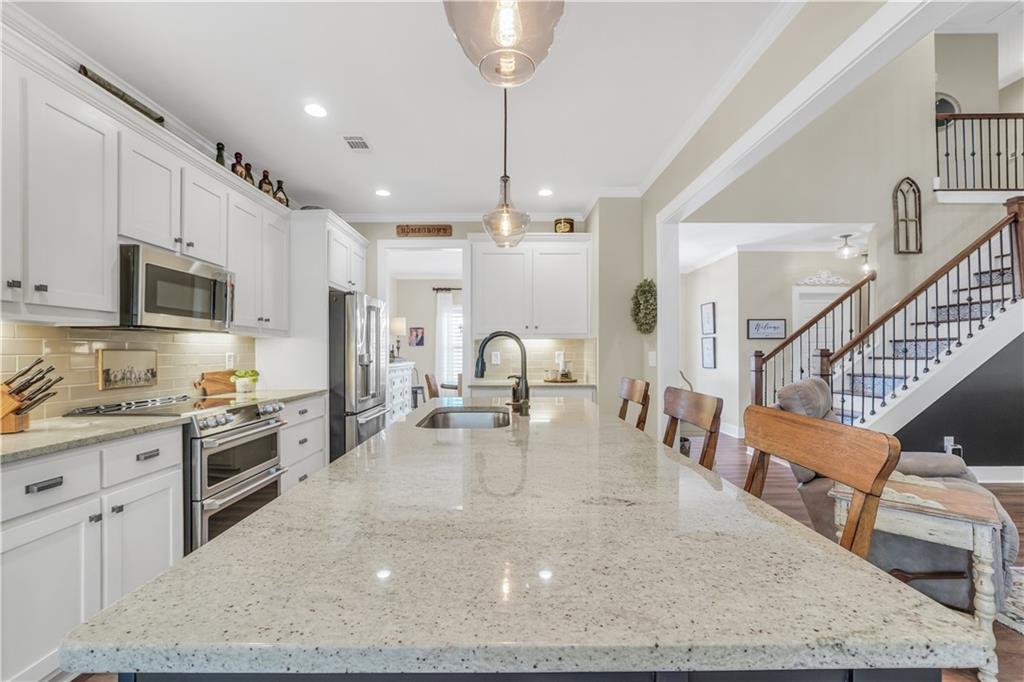 230 Alcovy Reserve Way Covington, GA 30014 - Photo 23 of 53 a kitchen with sink refrigerator and cabinets