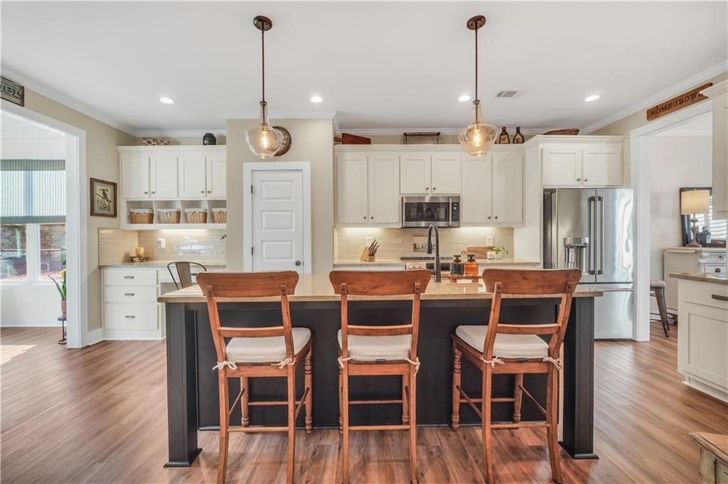 230 Alcovy Reserve Way Covington, GA 30014 - Photo 25 of 53 a dining room with stainless steel appliances kitchen island granite countertop a dining table chairs and refrigerator