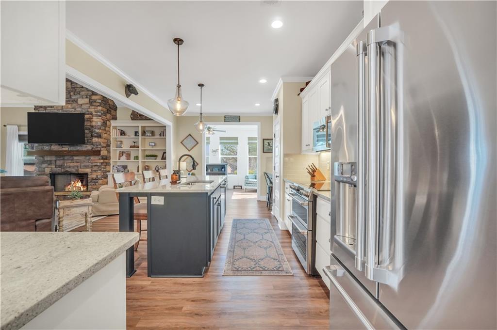 230 Alcovy Reserve Way Covington, GA 30014 - Photo 27 of 53 a kitchen with stainless steel appliances granite countertop a refrigerator a sink and a stove with wooden floor