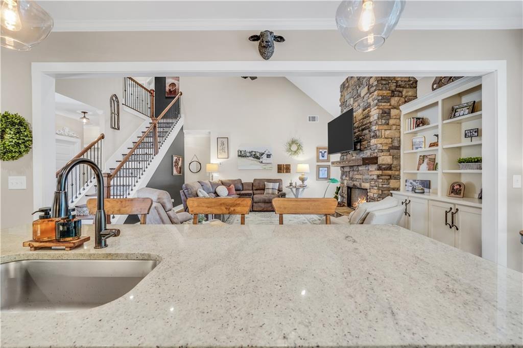 230 Alcovy Reserve Way Covington, GA 30014 - Photo 28 of 53 a living room with furniture and a chandelier