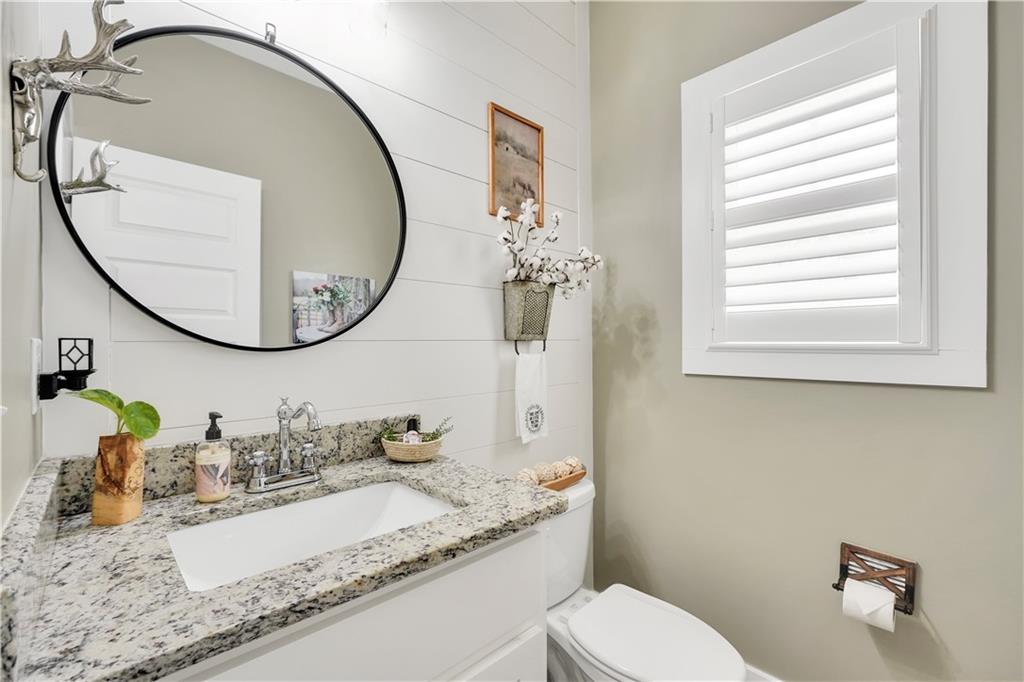 230 Alcovy Reserve Way Covington, GA 30014 - Photo 33 of 53 a bathroom with a granite countertop toilet a sink and a mirror