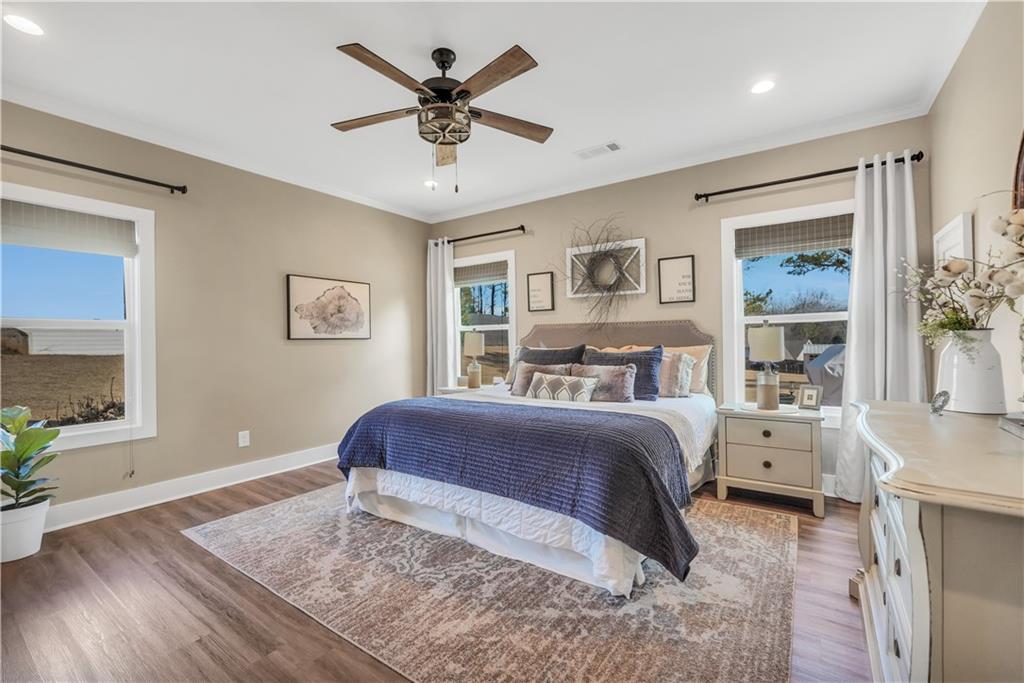 230 Alcovy Reserve Way Covington, GA 30014 - Photo 35 of 53 a spacious bedroom with a large bed and a chandelier