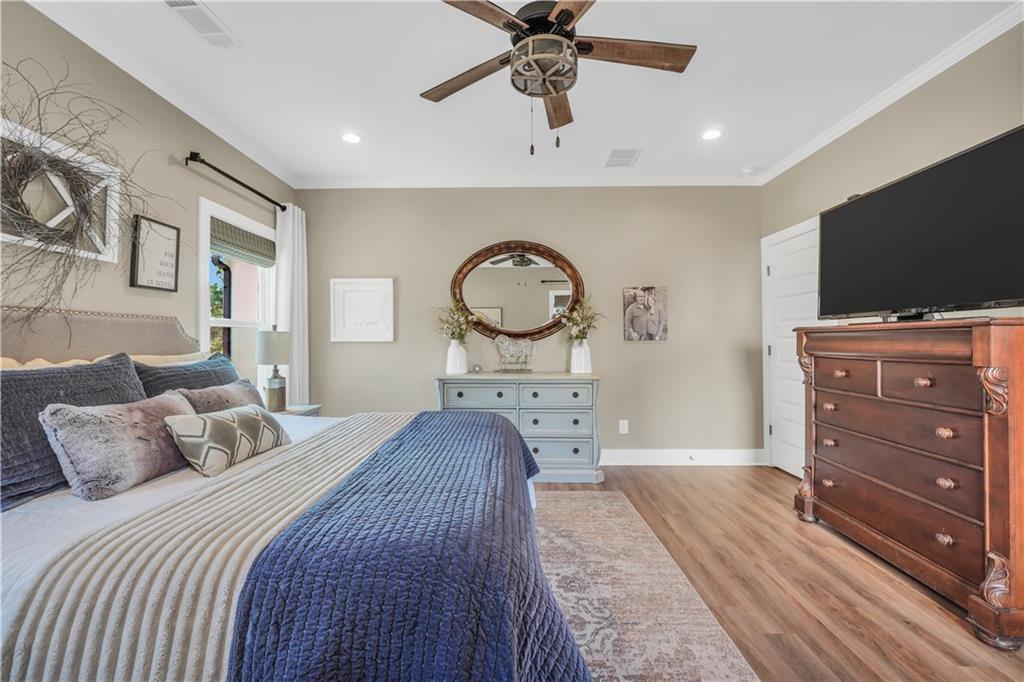 230 Alcovy Reserve Way Covington, GA 30014 - Photo 38 of 53 a bedroom with a bed a mirror on dresser and a flat screen tv