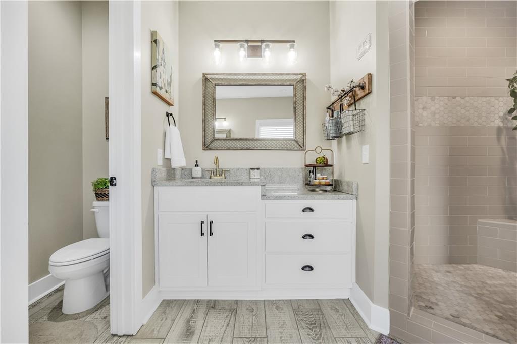 230 Alcovy Reserve Way Covington, GA 30014 - Photo 39 of 53 a bathroom with a sink a toilet and a mirror